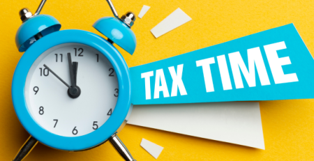 Image of a blue old-timey alarm clock on a bright yellow background with a TAX TIME banner