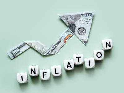 Inflation words with money arrow climbing higher