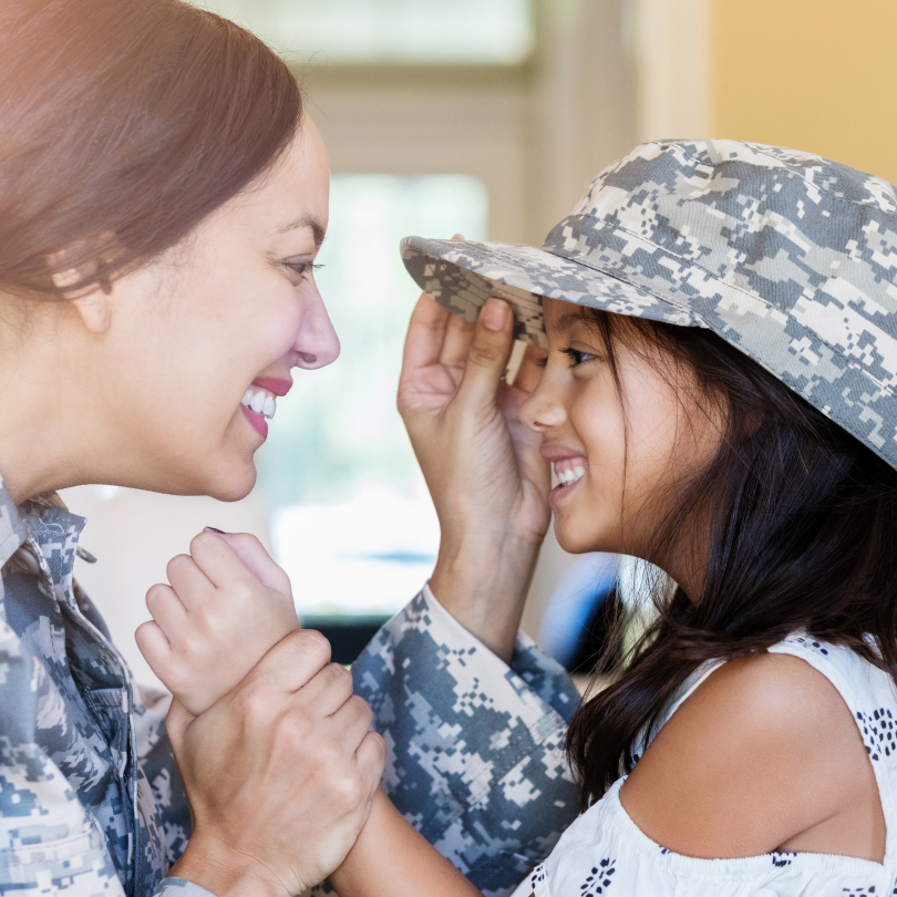 Frame 12 community hero giving her hat to child