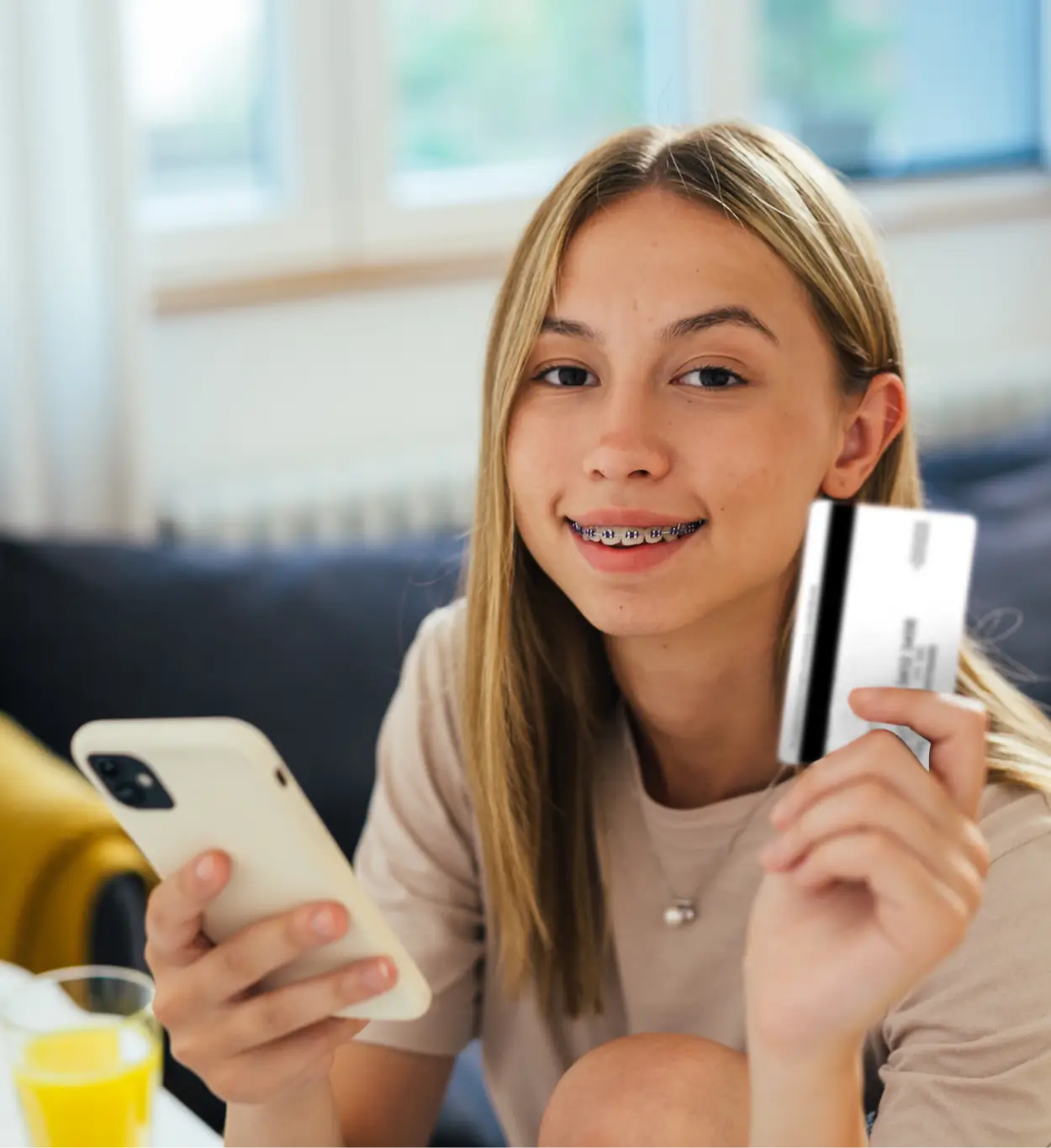 Girl smiling while holding debit card - Scott Credit Union Girl smiling while holding debit card