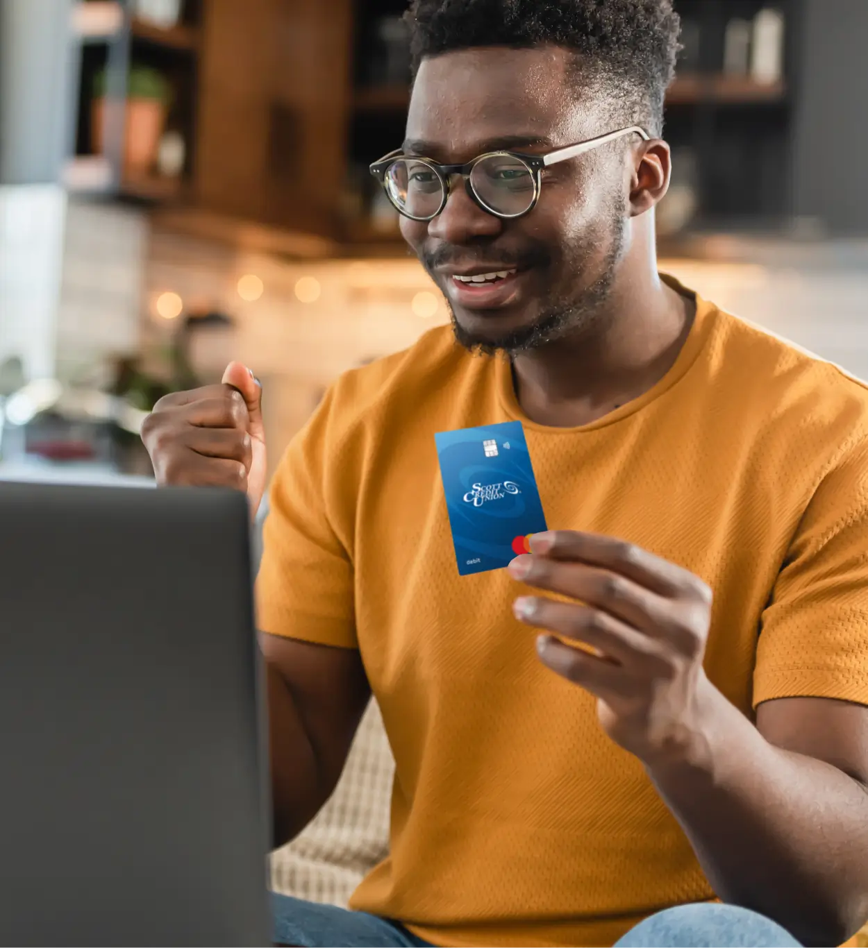 Smiling while holding debit card - Scott Credit Union Smiling while holding debit card