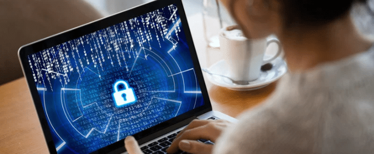 Woman using a laptop with a digital security padlock graphic protecting online accounts.